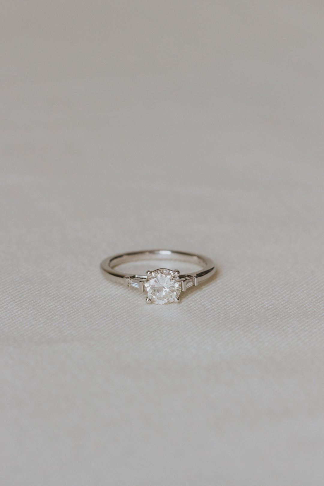 Diamond ring on a light gray fabric background